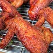Crispy, golden-brown Chinese-style chicken wings fresh from frying and packed with seasoned flavor.