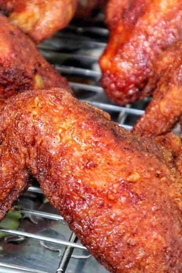 Crispy, golden-brown Chinese-style chicken wings fresh from frying and packed with seasoned flavor.