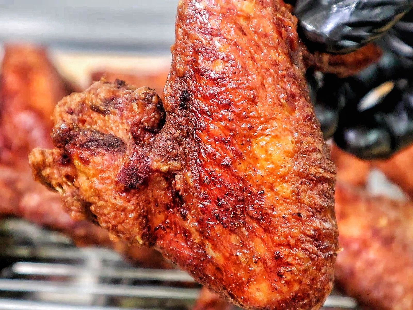 Crispy, golden-brown Chinese-style chicken wings fresh from frying and packed with seasoned flavor.