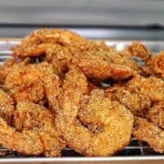 Golden, crispy Creole-seasoned fried shrimp, showcasing a crunchy cornmeal coating and deep-fried perfection.