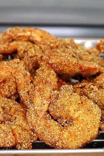 Golden, crispy Creole-seasoned fried shrimp, showcasing a crunchy cornmeal coating and deep-fried perfection.