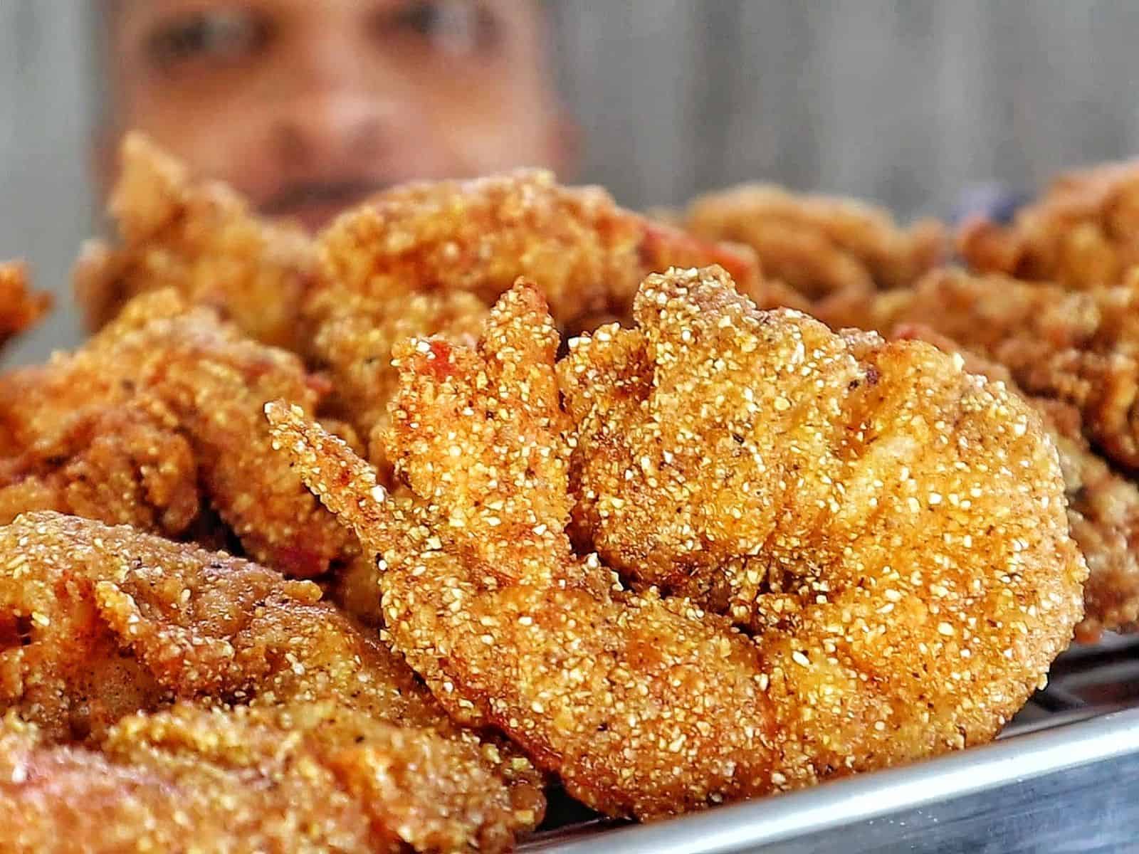 Golden, crispy Creole-seasoned fried shrimp, showcasing a crunchy cornmeal coating and deep-fried perfection.

