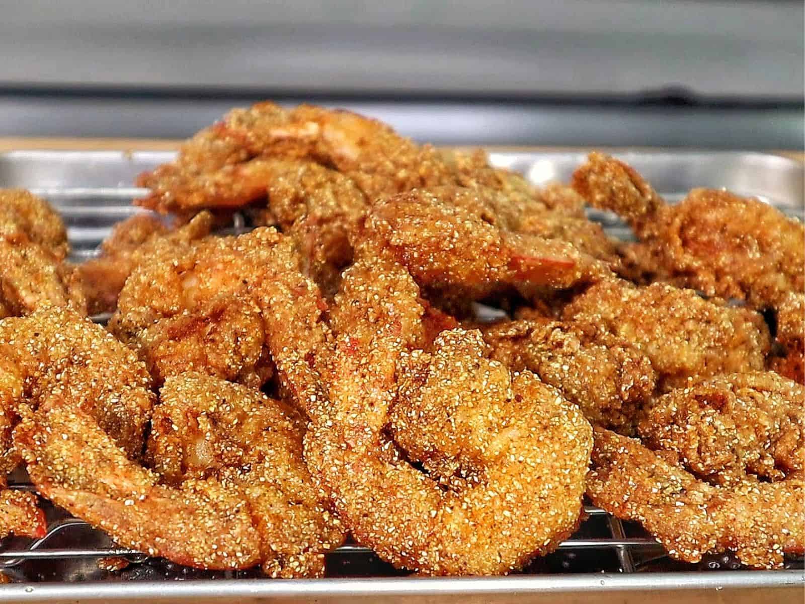 Golden, crispy Creole-seasoned fried shrimp, showcasing a crunchy cornmeal coating and deep-fried perfection.