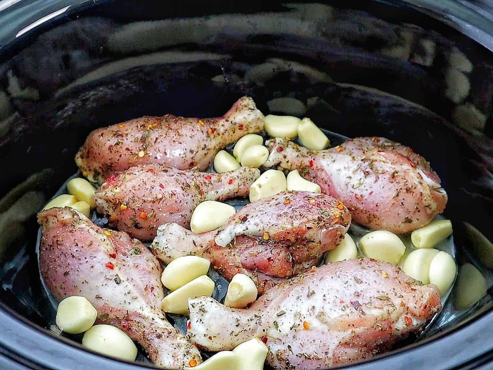 Golden brown, slow-cooked Italian garlic chicken thighs in savory juices, served with tender garlic cloves.