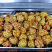 Golden brown Southern fried okra on a wire rack, crispy and seasoned with a cornmeal crust.