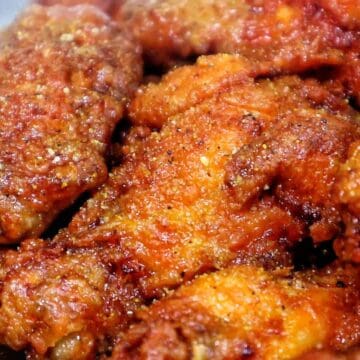 Spicy lemon lime chicken wing with crispy seasoned coating and sauce.