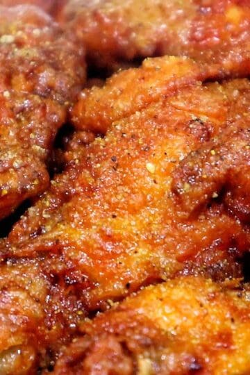 Spicy lemon lime chicken wing with crispy seasoned coating and sauce.