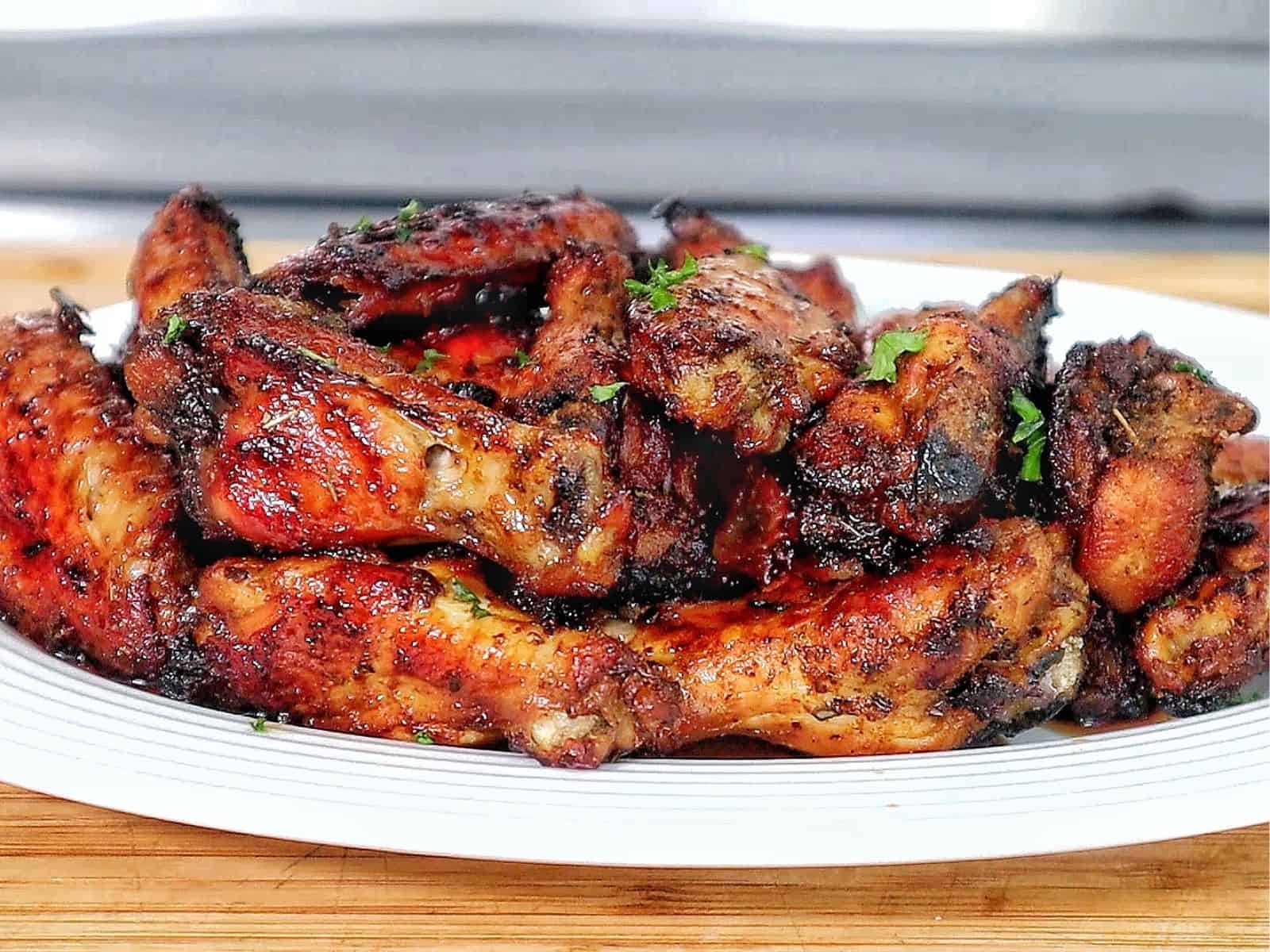 Crispy, golden-brown Cajun chicken wings, glazed with a sweet and smoky brown sugar seasoning and garnished with fresh parsley