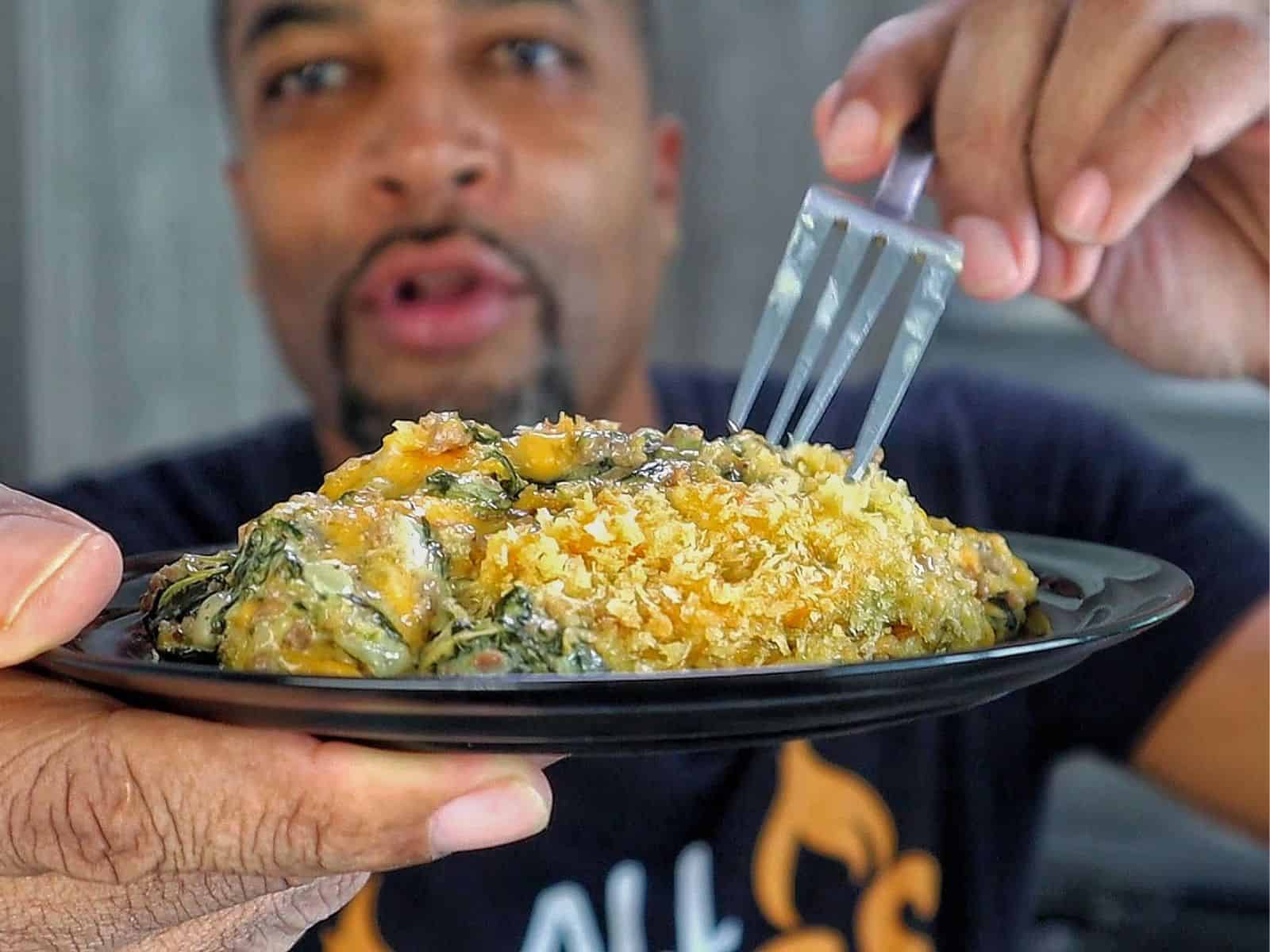 creamy ground beef and spinach casserole in a baking dish, with gooey melted cheese stretching and a golden, crispy topping.