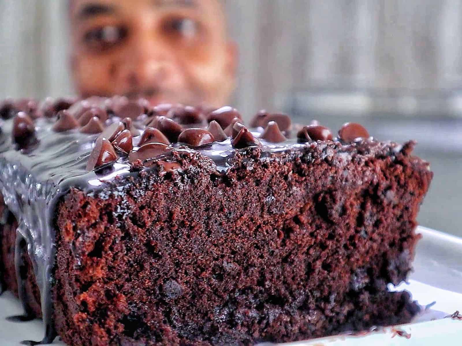 A rich, fudgy loaf of brownie bread topped with hot fudge and a sprinkle of chocolate chips.