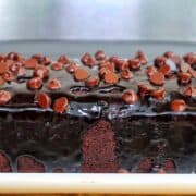 A rich, fudgy loaf of brownie bread topped with hot fudge and a sprinkle of chocolate chips.