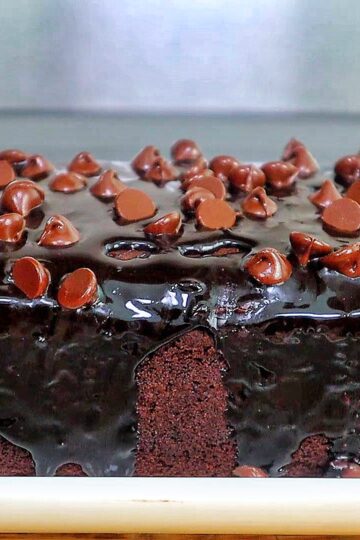 A rich, fudgy loaf of brownie bread topped with hot fudge and a sprinkle of chocolate chips.