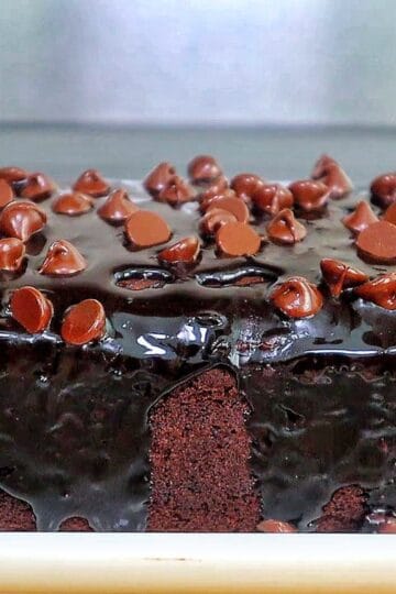 A rich, fudgy loaf of brownie bread topped with hot fudge and a sprinkle of chocolate chips.