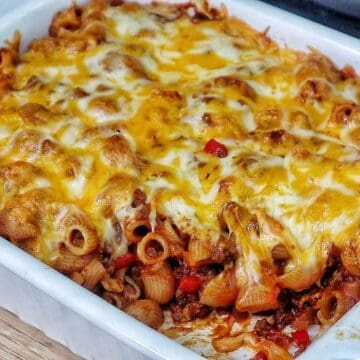 Baked sloppy joe casserole, topped with melted cheddar and mozzarella cheese, bubbling and golden brown.