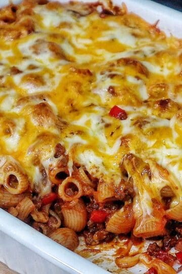 Baked sloppy joe casserole, topped with melted cheddar and mozzarella cheese, bubbling and golden brown.