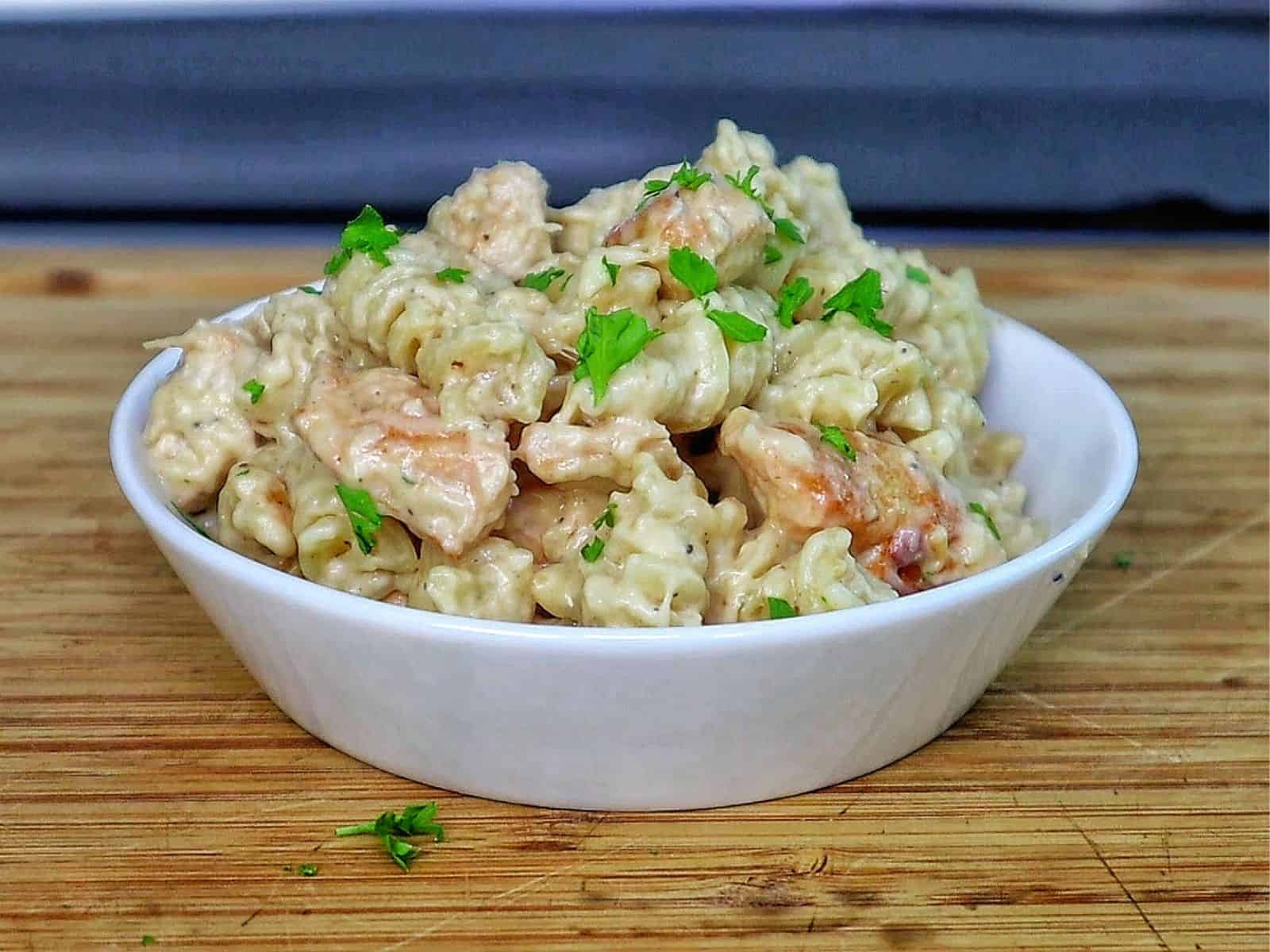 golden-brown baked garlic parmesan chicken pasta, topped with bubbly melted cheese and garnished with fresh parsley