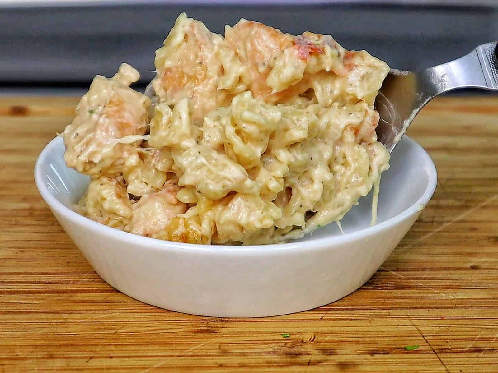 golden-brown baked garlic parmesan chicken pasta, topped with bubbly melted cheese and garnished with fresh parsley