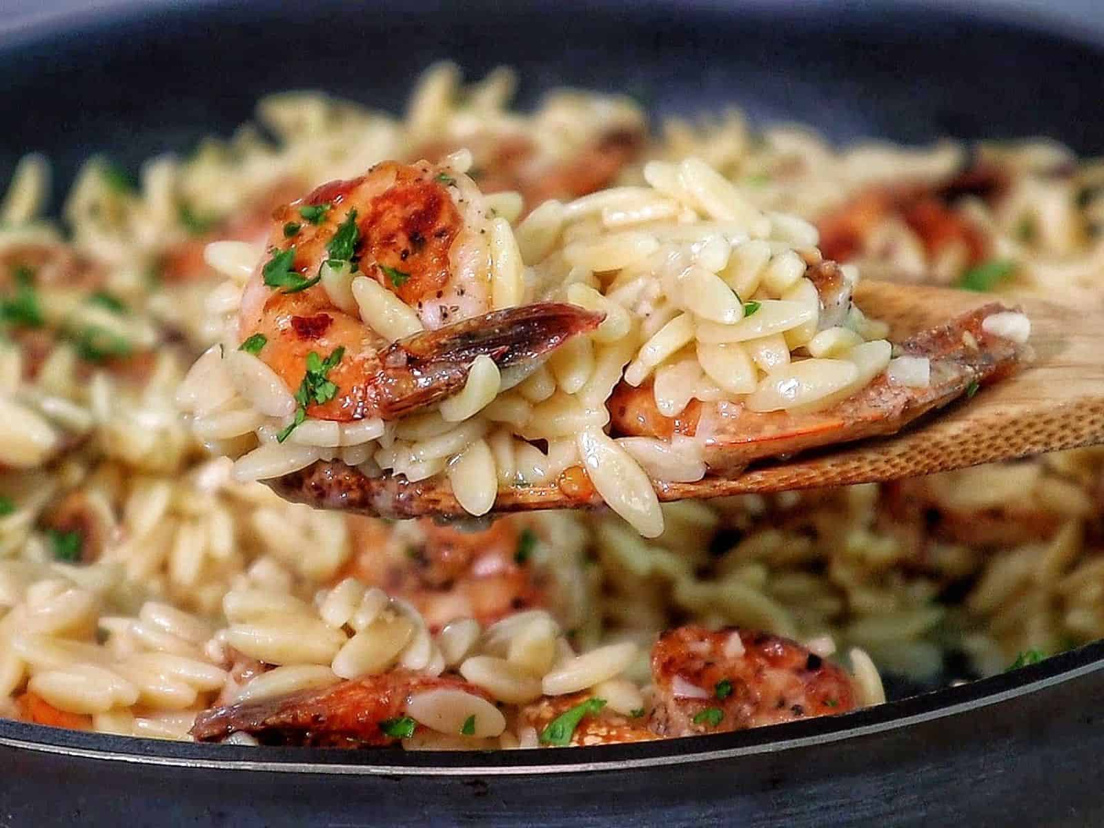creamy orzo pasta and pan-seared shrimp, garnished with fresh parsley for a vibrant, comforting seafood pasta dish.