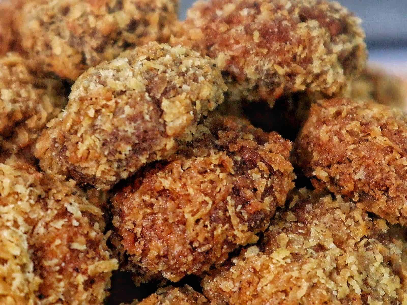 Golden, crispy Spicy Fried Mushrooms piled high, showing their crunchy coating and perfectly fried texture.