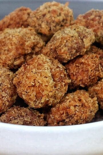 Golden, crispy Spicy Fried Mushrooms piled high, showing their crunchy coating and perfectly fried texture.