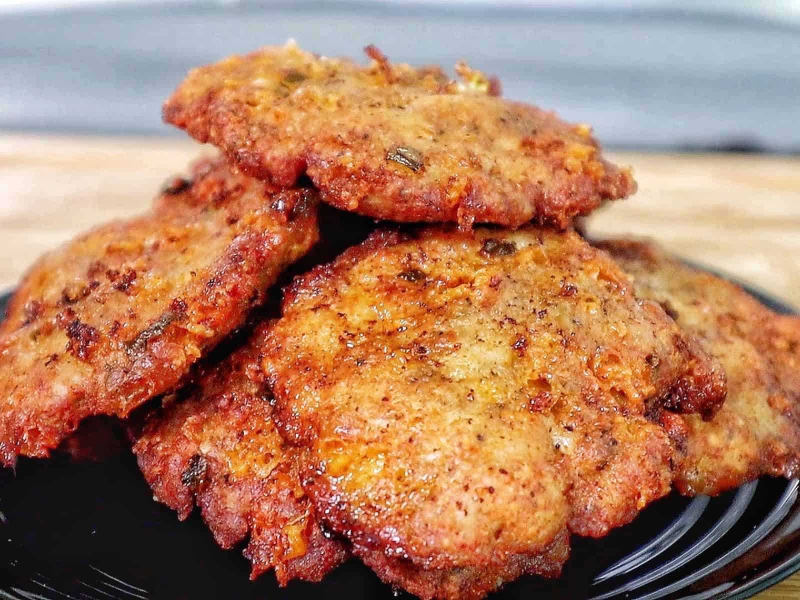 golden brown cheesy chicken fritters with crispy edges, juicy texture, and melted cheese glistening on the surface