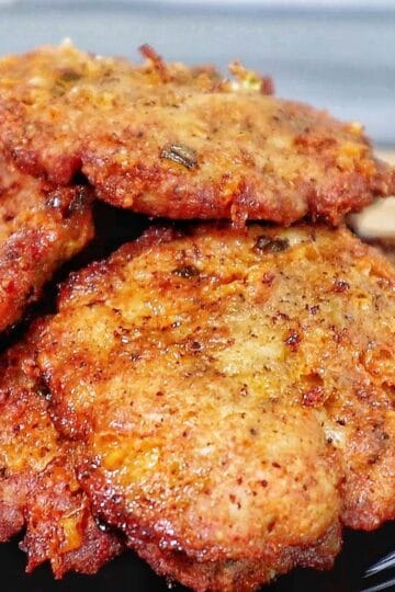 golden brown cheesy chicken fritters with crispy edges, juicy texture, and melted cheese glistening on the surface