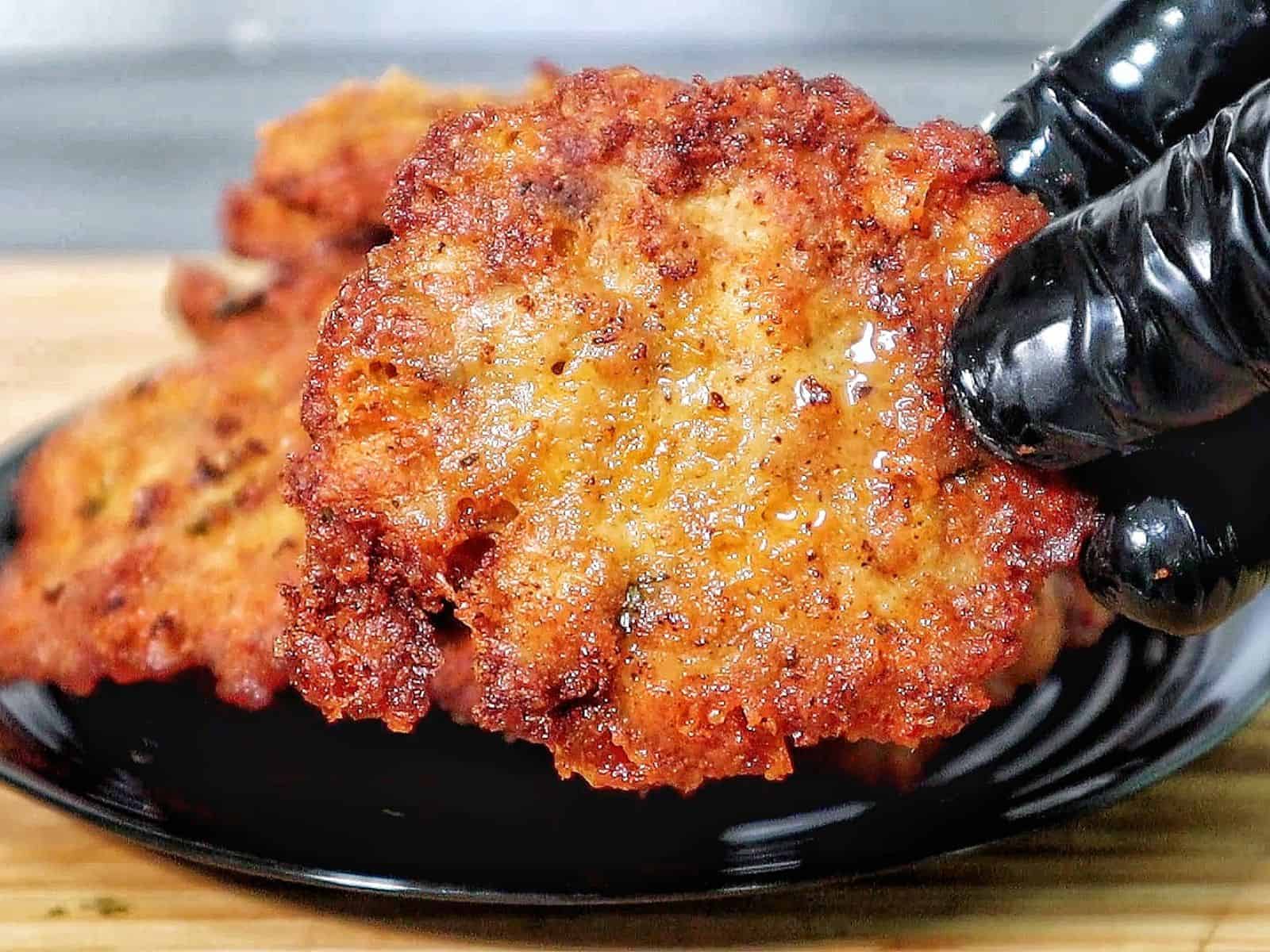 golden brown cheesy chicken fritters with crispy edges, juicy texture, and melted cheese glistening on the surface