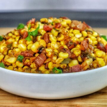 Southern skillet fried corn mixed with crispy bacon, green peppers, onions, and seasonings.