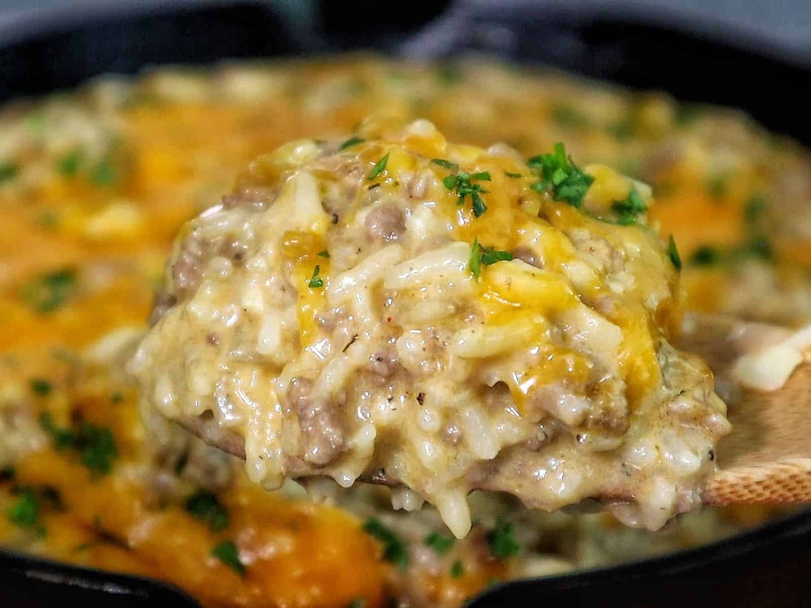 Creamy garlic butter beef and rice skillet topped with melted cheddar and parsley