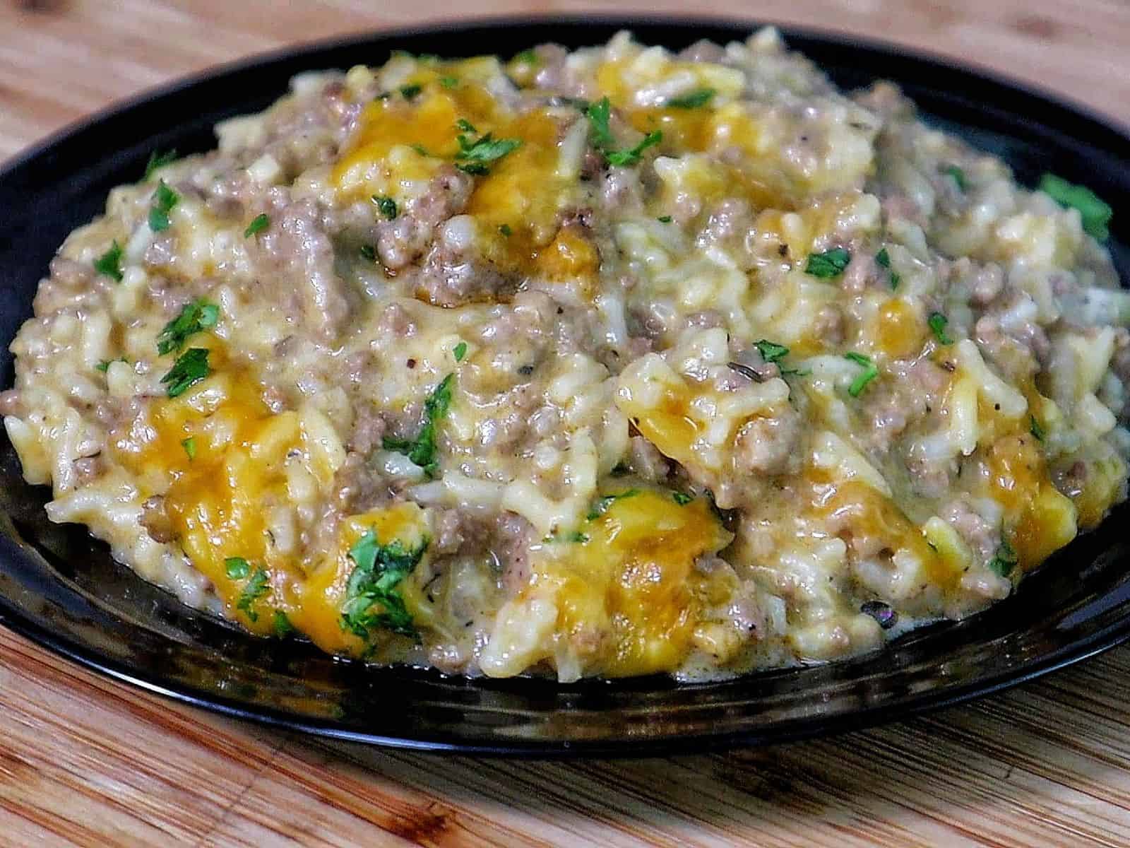 Creamy garlic butter beef and rice skillet topped with melted cheddar and parsley