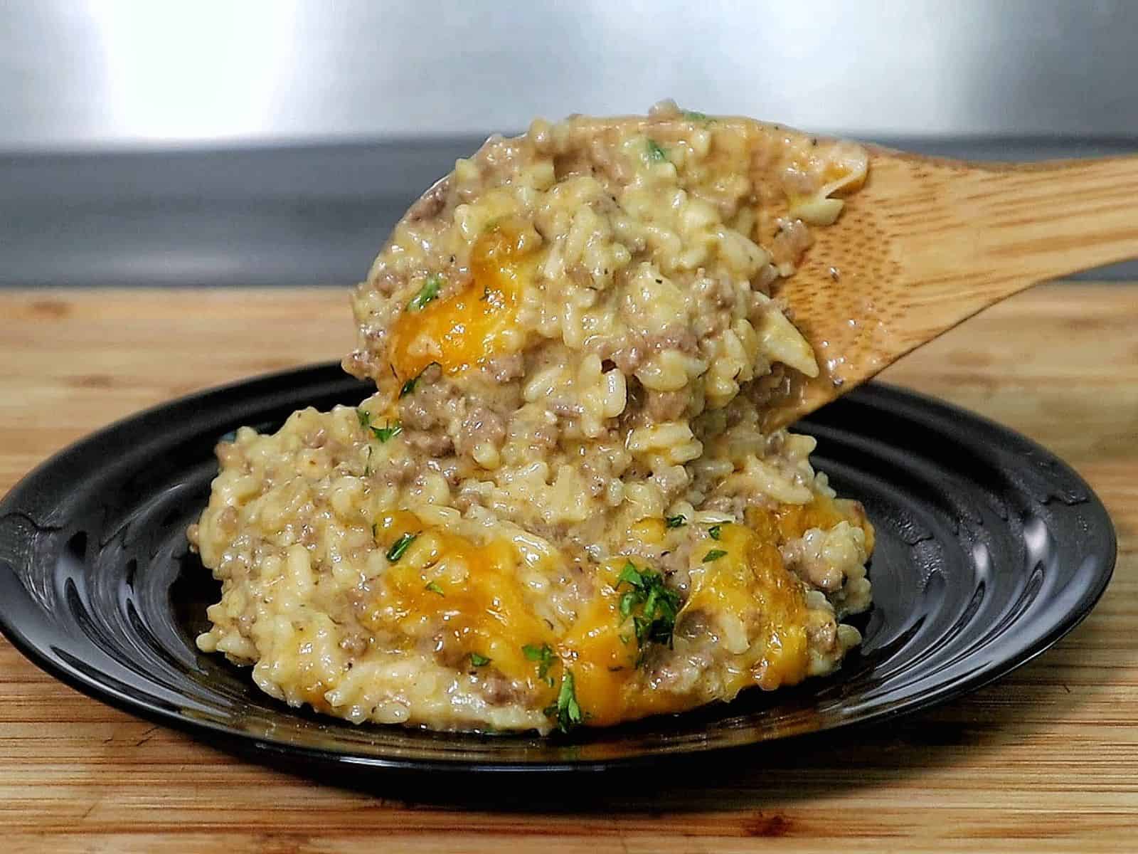 Creamy garlic butter beef and rice skillet topped with melted cheddar and parsley