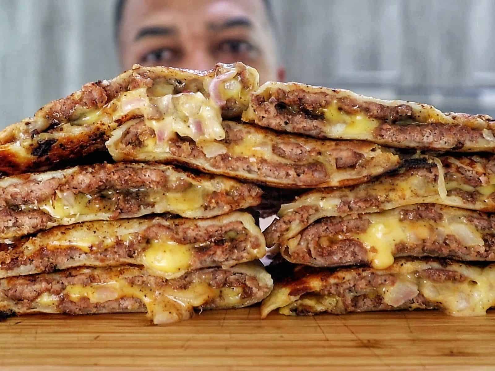 Smashburger quesadillas filled with seasoned ground beef, melted American cheese, diced onions, in a crispy toasted tortilla.