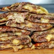 Smashburger quesadillas filled with seasoned ground beef, melted American cheese, diced onions, in a crispy toasted tortilla.