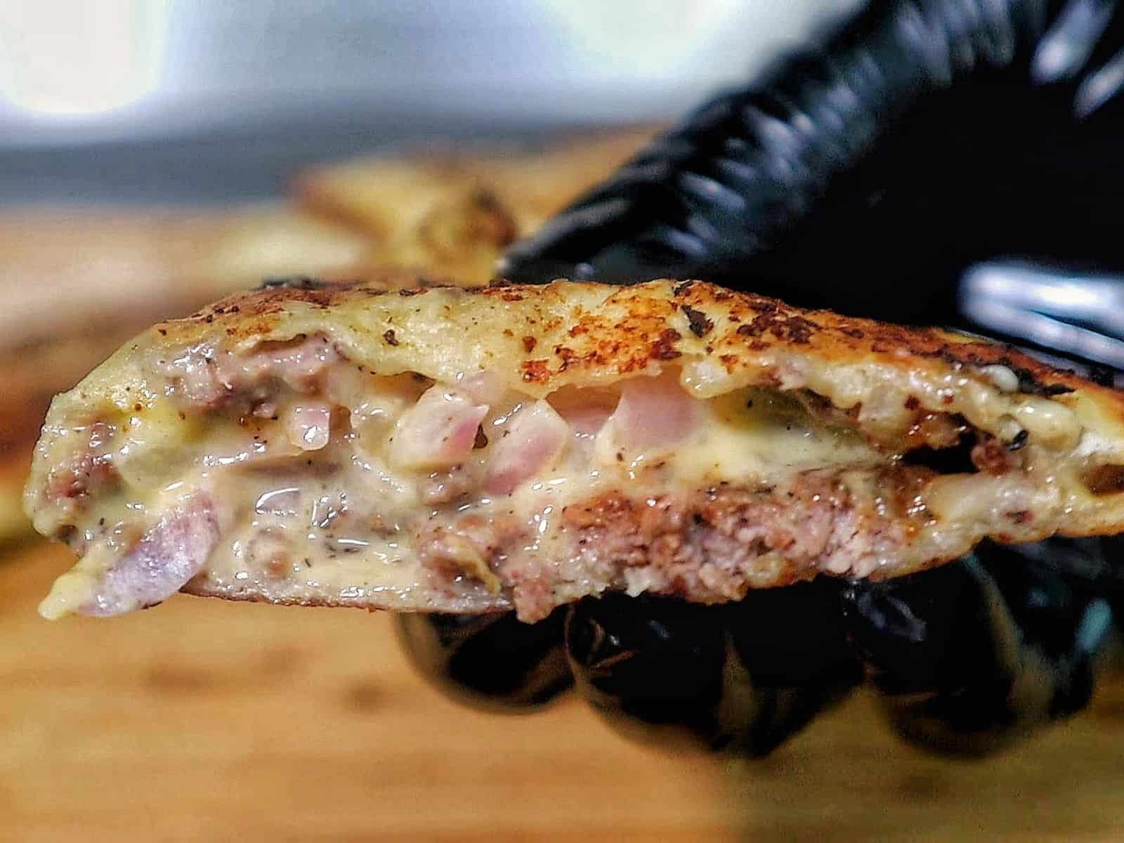 Smashburger quesadillas filled with seasoned ground beef, melted American cheese, diced onions, in a crispy toasted tortilla.