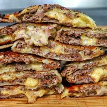 Smashburger quesadillas filled with seasoned ground beef, melted American cheese, diced onions, in a crispy toasted tortilla.