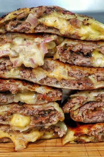 Smashburger quesadillas filled with seasoned ground beef, melted American cheese, diced onions, in a crispy toasted tortilla.