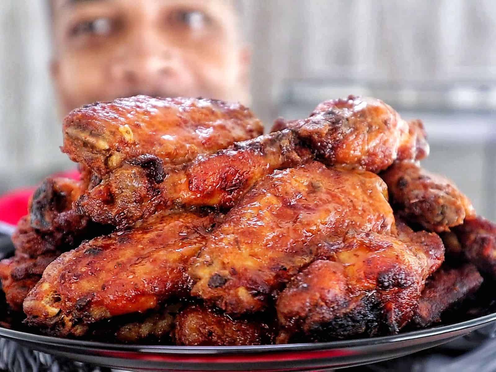Crispy air-fried spicy blackened chicken wings coated in a buttery hot sauce glaze, served fresh and ready to eat.