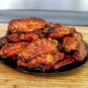 Crispy air-fried spicy blackened chicken wings coated in a buttery hot sauce glaze, served fresh and ready to eat.