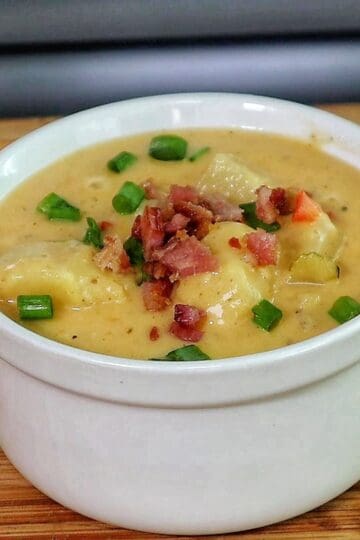 Creamy Cajun potato soup topped with crispy bacon, cheddar cheese, and green onions.