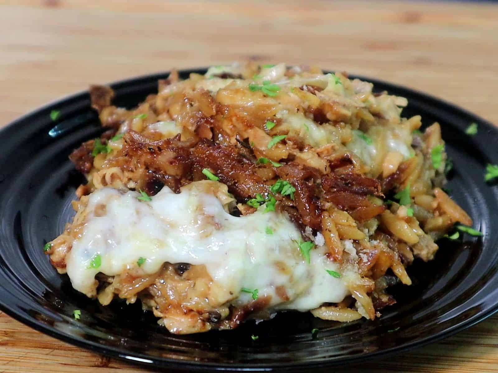 Golden, cheesy French onion chicken casserole made with orzo pasta, caramelized onions, shredded chicken, and melted mozzarella