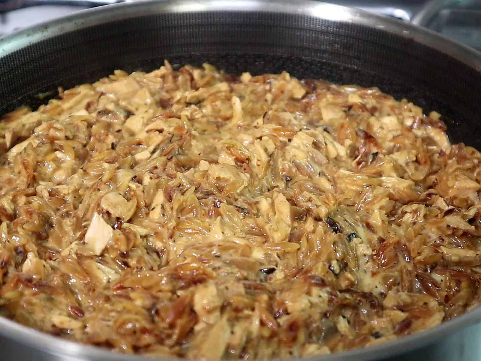 Golden, cheesy French onion chicken casserole made with orzo pasta, caramelized onions, shredded chicken, and melted mozzarella