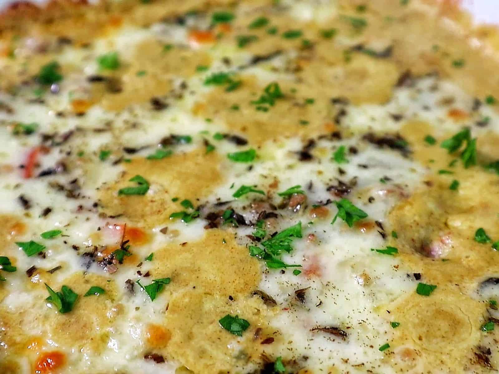 Cheesy Philly cheesesteak casserole with ground beef, bell peppers, mushrooms, and melted provolone and mozzarella cheese.