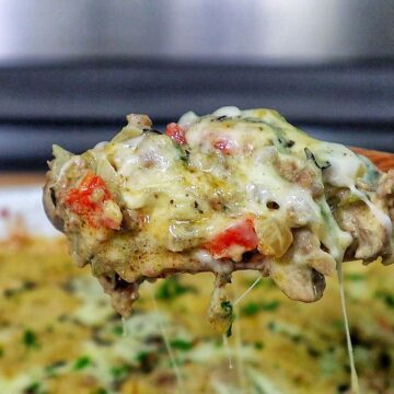 Cheesy Philly cheesesteak casserole with ground beef, bell peppers, mushrooms, and melted provolone and mozzarella cheese.