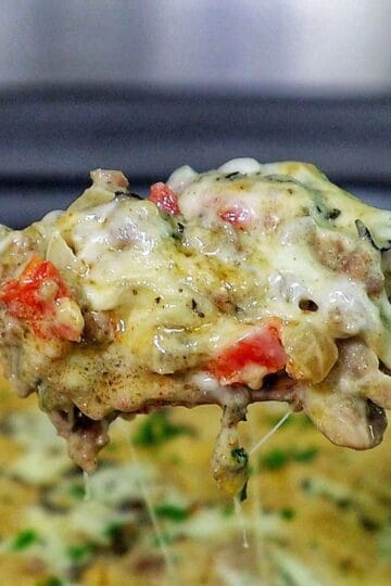 Cheesy Philly cheesesteak casserole with ground beef, bell peppers, mushrooms, and melted provolone and mozzarella cheese.