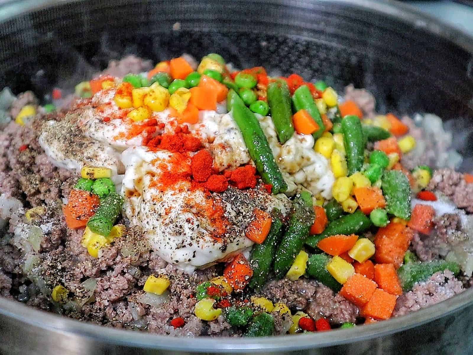Cheddar Bay beef cobbler with a golden biscuit topping, layered over a creamy ground beef and vegetable filling.