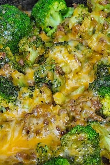 Cheesy ground beef and broccoli skillet with melted cheddar and colby jack cheese, cooked in a pan.
