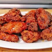 Crispy fried chicken wings coated in a glossy sticky Hennessy glaze.