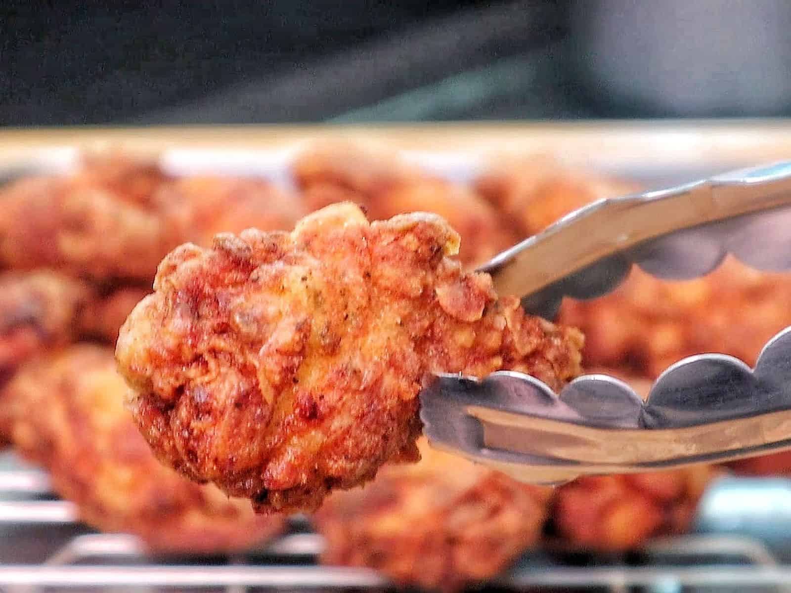 Crispy fried chicken wings coated in a glossy sticky Hennessy glaze.