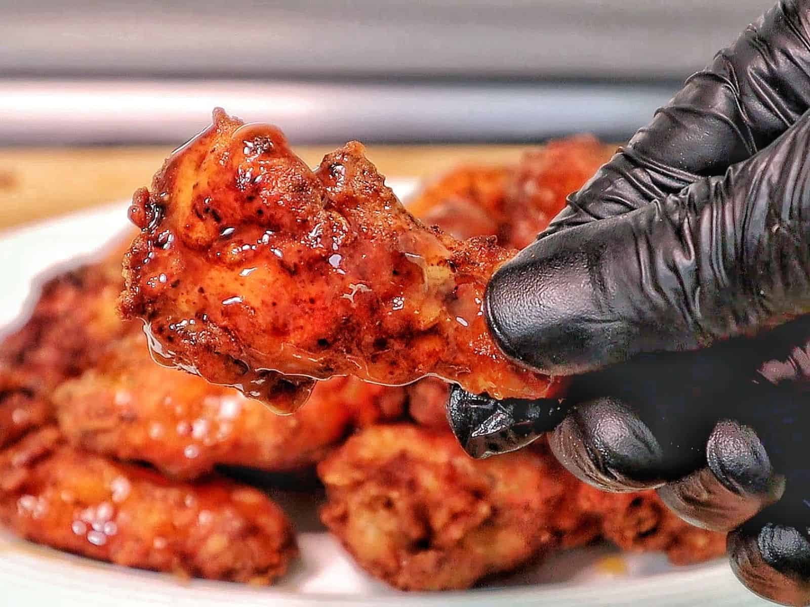 Crispy fried chicken wings coated in a glossy sticky Hennessy glaze.