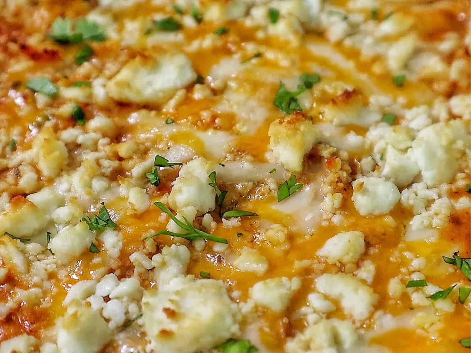 Creamy street corn chicken casserole baked with melted cheese, corn, shredded chicken, and garnished with cilantro.